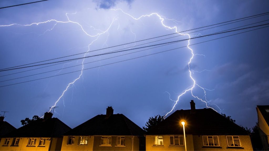 Lightening strikes a house on a stormy night