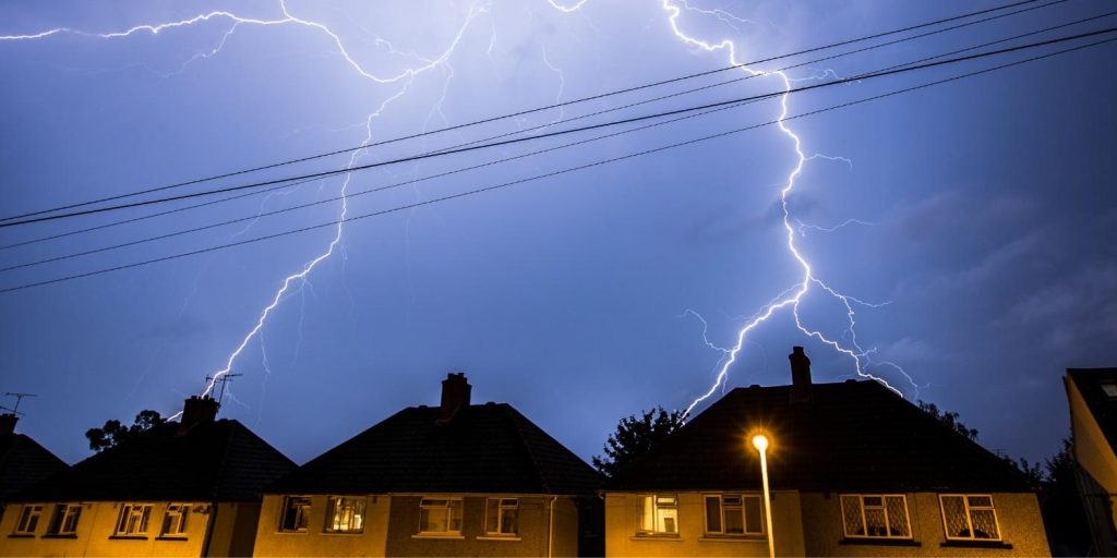 Lightening strikes a house on a stormy night