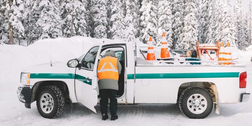 Person standing near car with traffic cones