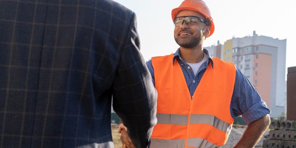 Building and construction worker on the site with architect