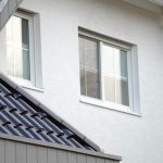 Low angle shot of a white building with two windows