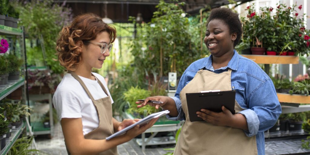Two women running a small greenhouse business