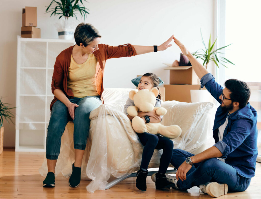 Happy family having fun while moving into their new home