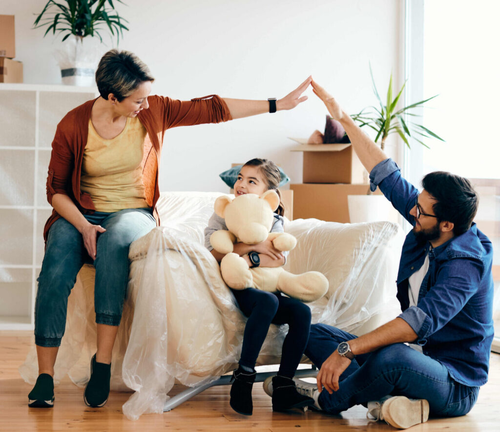 Happy family having fun while moving into their new home