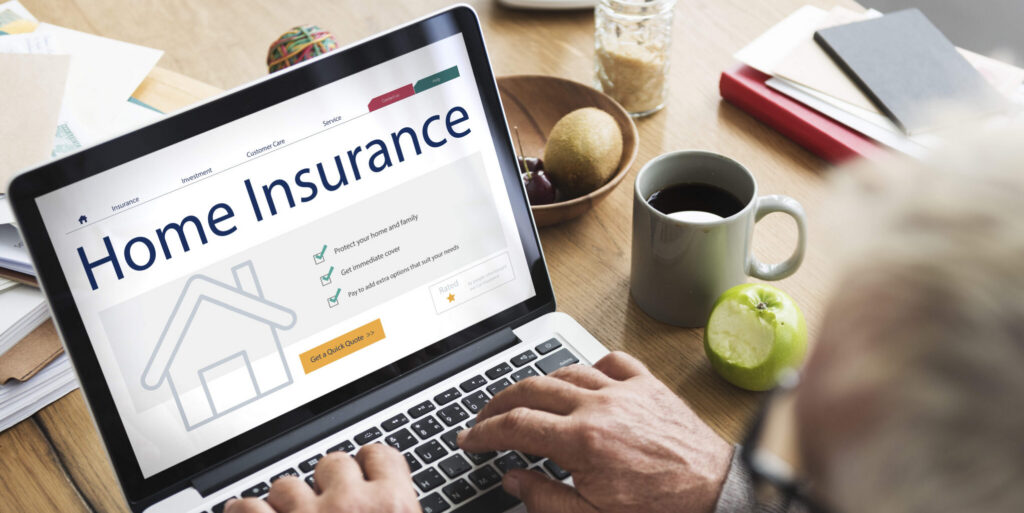 A man looking up home insurance on his laptop