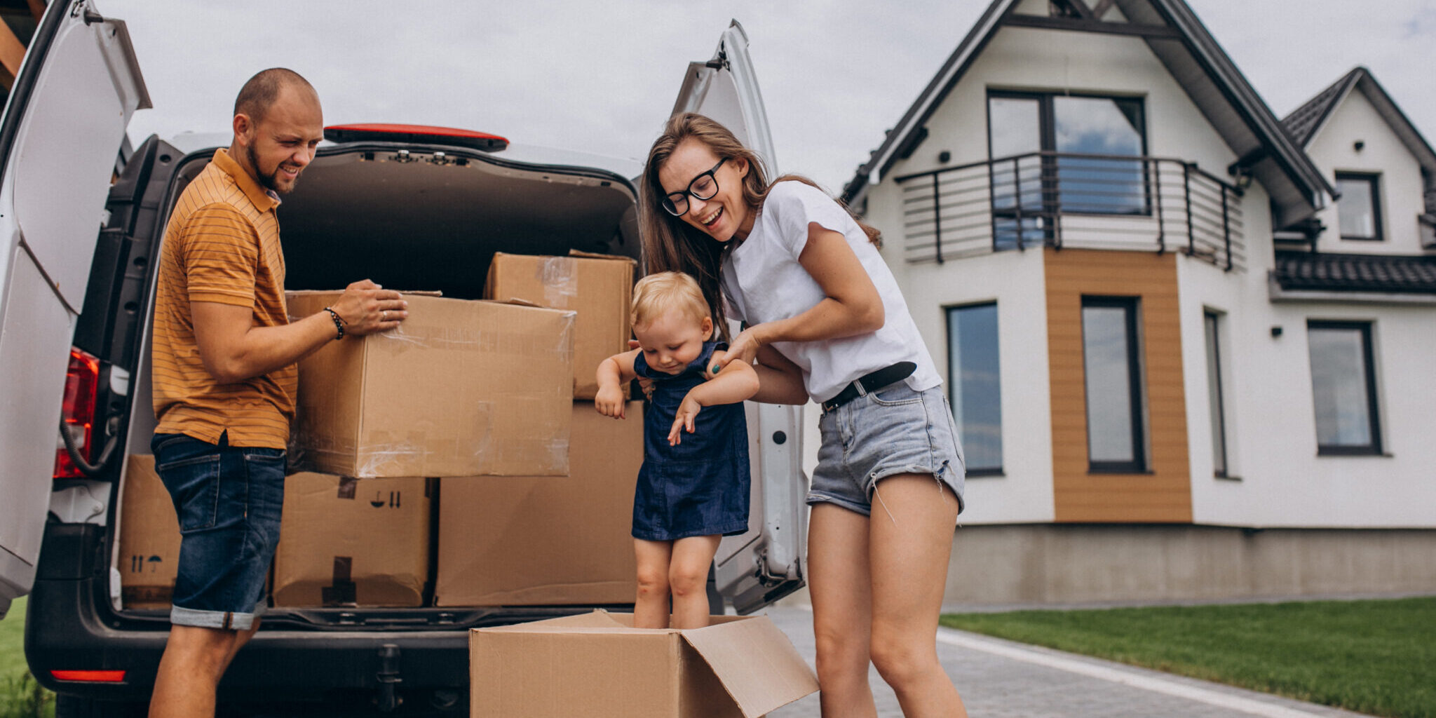Young family with little daughter moving into new house